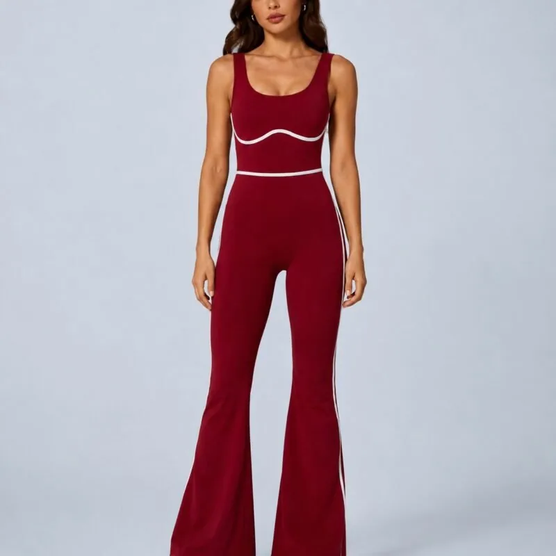 Crimson red seamless scoop-back flare jumpsuit — front view with white piping and bell-bottom legs