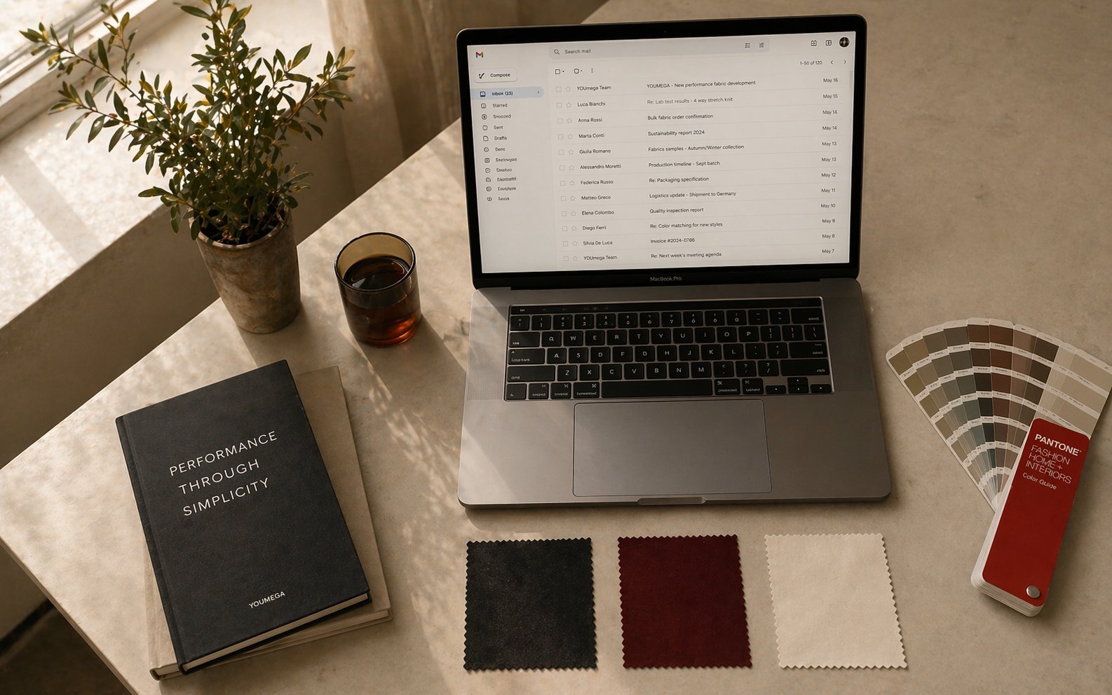 Designer sending tech pack and reference images from MacBook