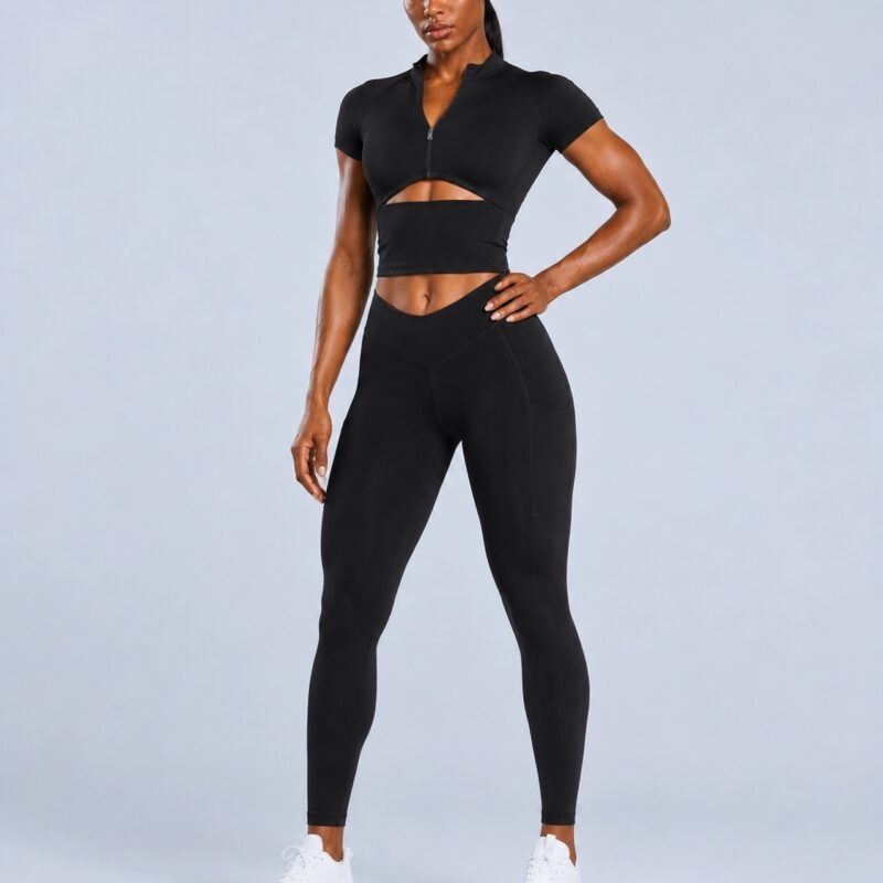 Black zip-front cutout crop top with V-waist pocket leggings — front view