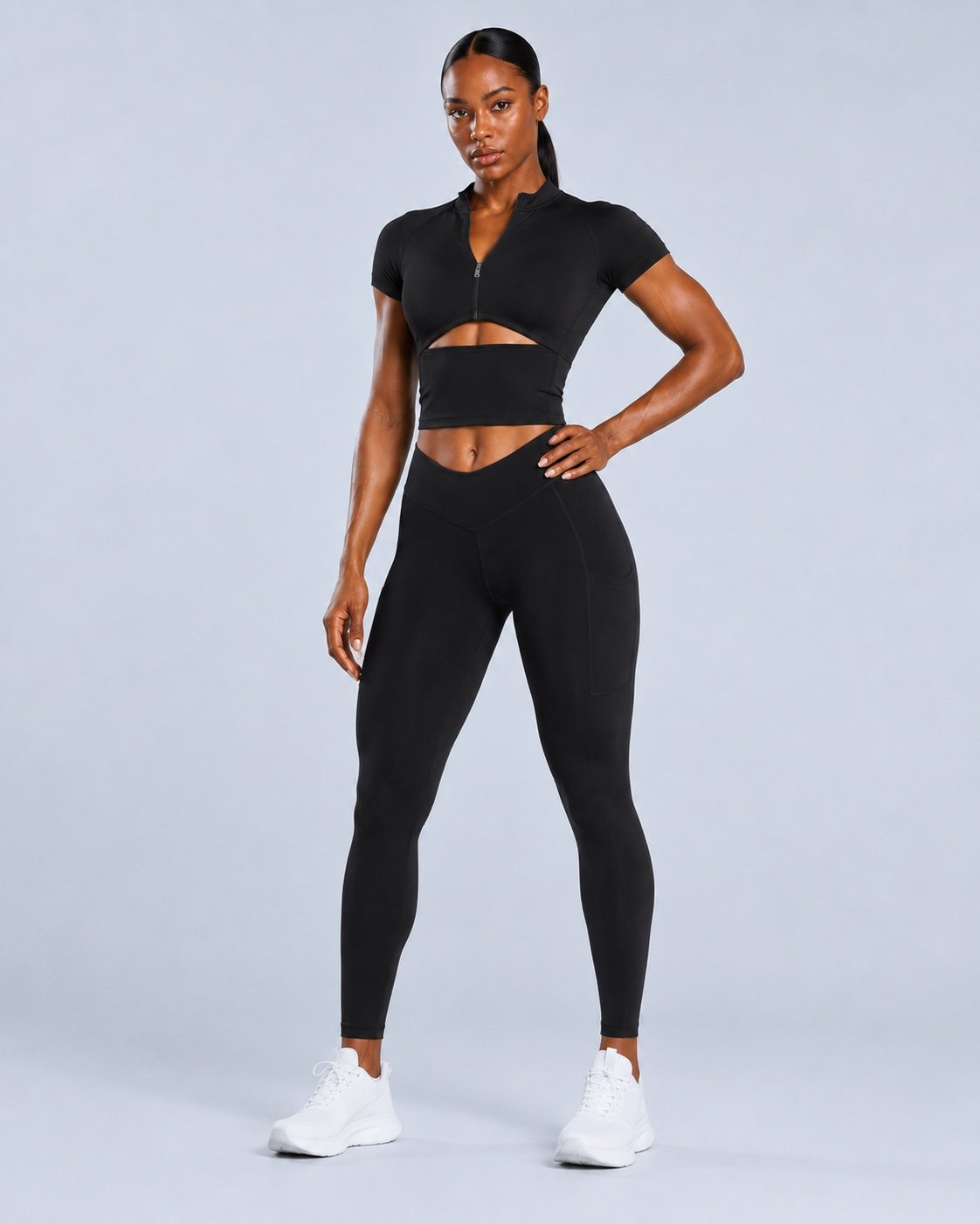 Conjunto negro de top con cremallera y leggings cintura V con bolsillos — vista frontal