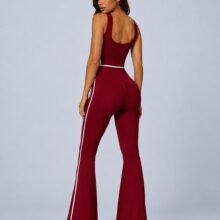 Seamless scoop-back flare jumpsuit — front view with white piping and bell-bottom legs