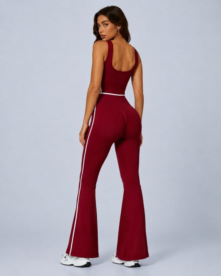 Seamless scoop-back flare jumpsuit — front view with white piping and bell-bottom legs