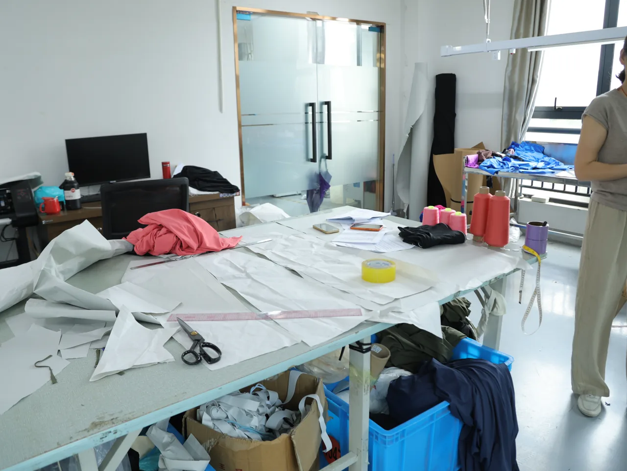 Fabric laid out for pattern cutting at the YOUMEGA factory