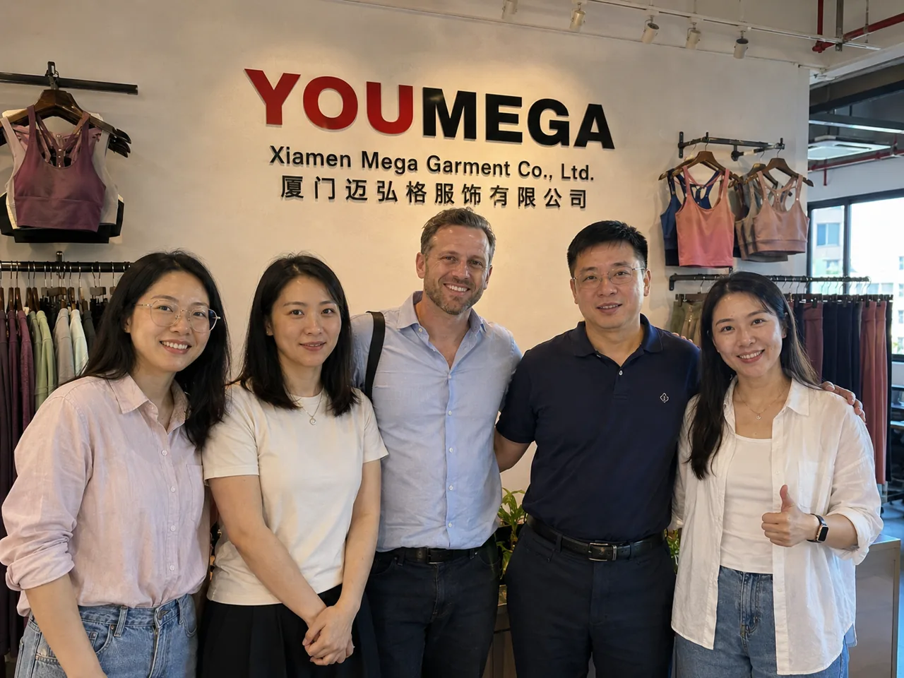 The YOUMEGA team with a visiting international brand client at the showroom