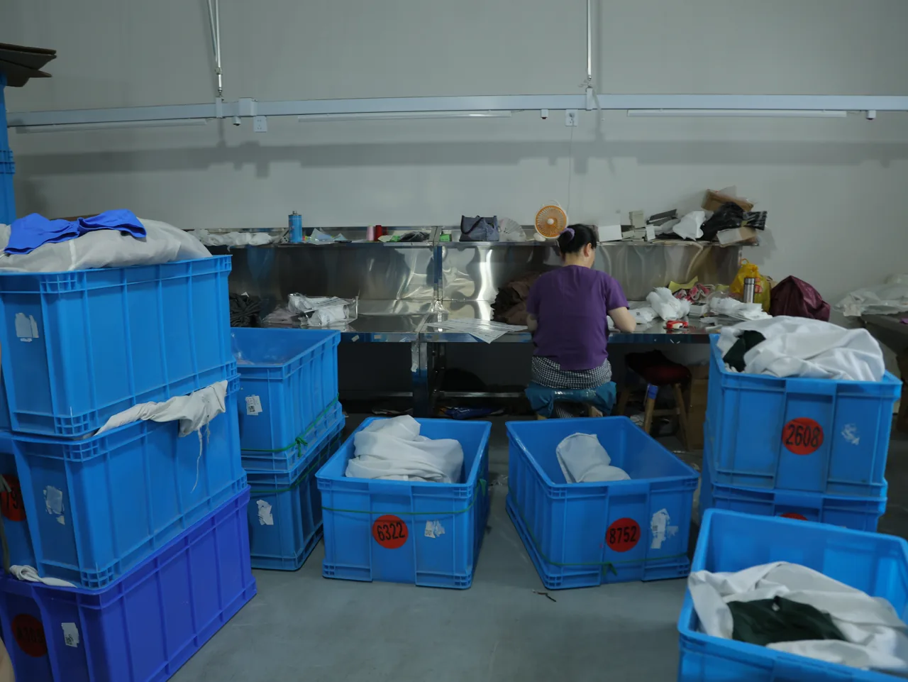 Activewear goods sorted in bins for handling and dispatch at YOUMEGA