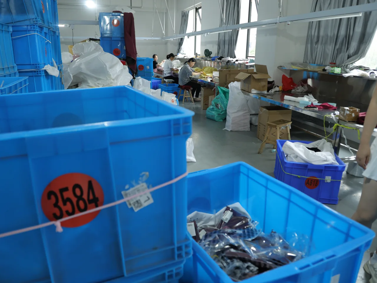 In-line QC bins with batch numbers on the YOUMEGA production floor