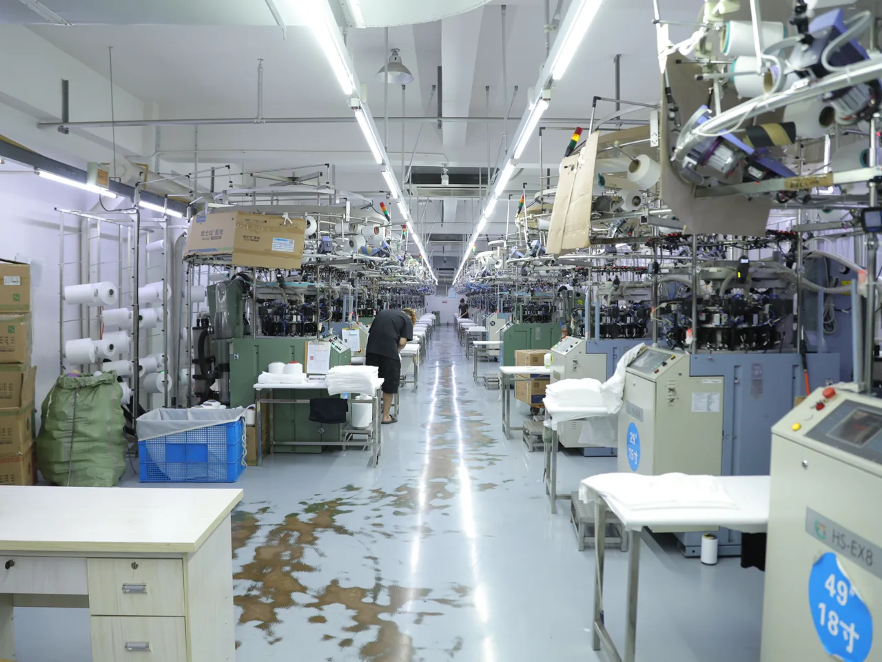 YOUMEGA staff reviewing an order and sample at the production office