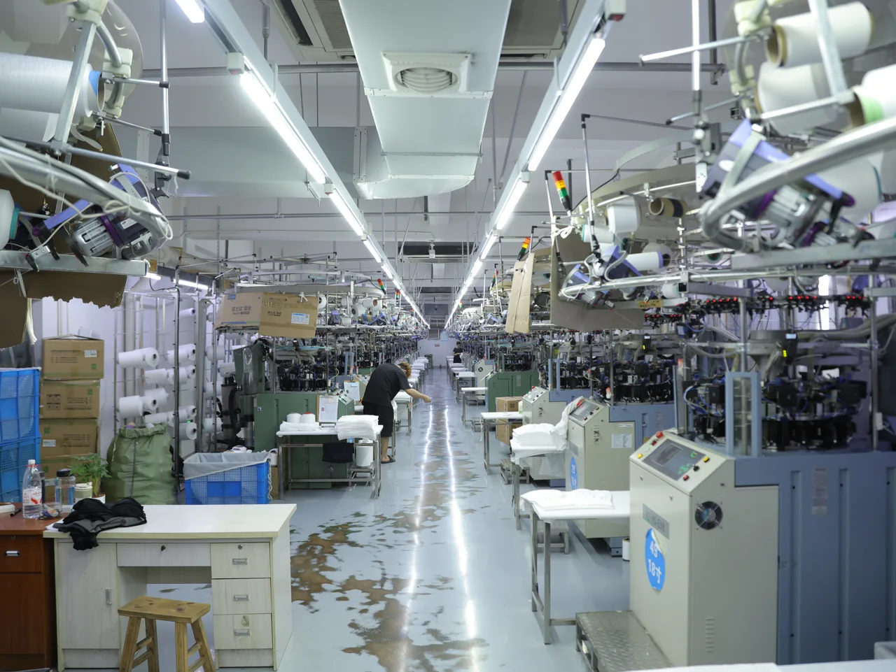 Rows of seamless knitting machines running at the YOUMEGA seamless facility