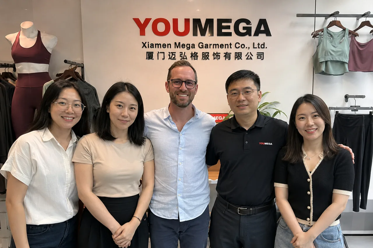 The YOUMEGA (Xiamen Mega Garment) team with a visiting brand client