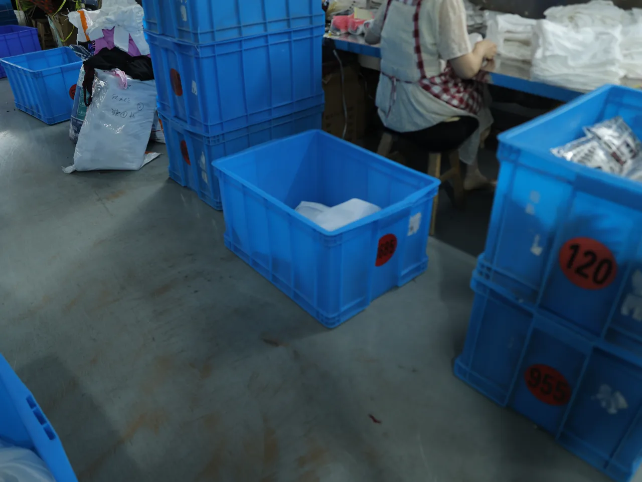 Work-in-progress activewear bins during in-line inspection at YOUMEGA